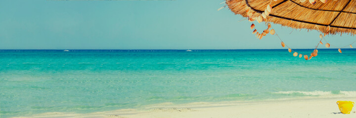 Fototapeta na wymiar Empty tropical beach background with umbrella. Horizon with sky and white sand