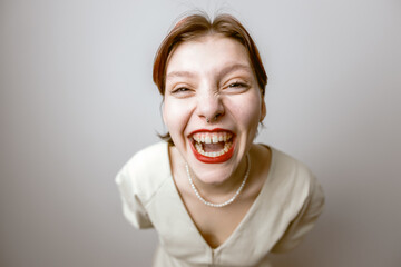 Portrait of a laughing, cheerful girl, close-up, light background