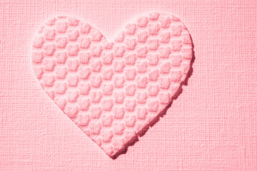 cute pink heart from textured material on the table