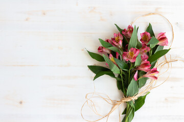 Alstroemeria bouquet on white wood background