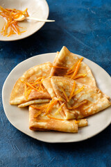 Crepes suzette with orange sauce and zest.