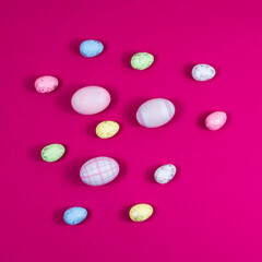 Colorful Easter eggs on a red raspberry background with copy space. The basis for the postcard.