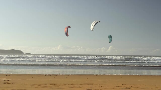 Kiteboarding activity in the waters of Morocco, Essaouira. Kiteboard, surfer, sea, ocean, waves, board, extreme sport, sportsman, summer, vacation / 4K Video Footage