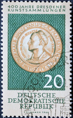 GERMANY, DDR - CIRCA 1960 : a postage stamp from Germany, GDR showing a foam coin (1518) with a portrait of the painter Hans Burgkmair (1473–1531). 400 years of Dresden art collections