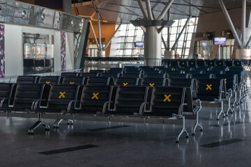 A lot of seats in the airport's international terminal are completely empty. There are no passengers at the airport. No people at the airport during the covid 19 coronavirus pandemic
