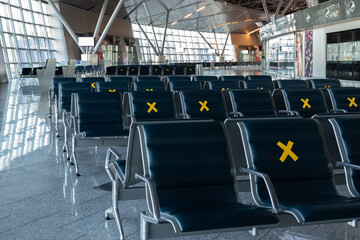 A lot of seats in the airport's international terminal are completely empty. There are no...