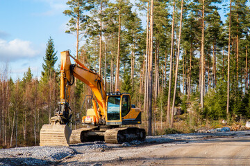 Yellow excavator building a road deep in the forest. Rusko, Finland. © Finmiki