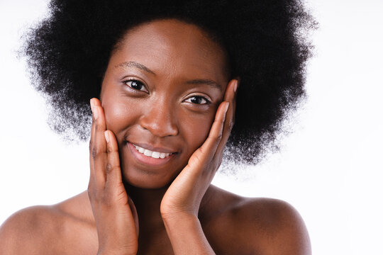 Attractive african teenage girl with clear skin shirtless isolated in white background. Cropped shot