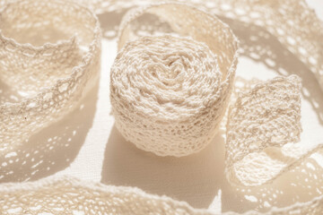 Pale beige lace closeup on a white table