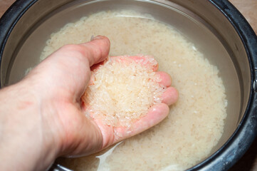 male hand washes rice