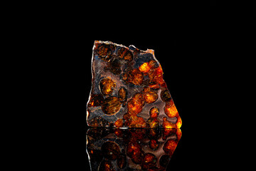 Macro stone mineral meteorite on a black background © Minakryn Ruslan 