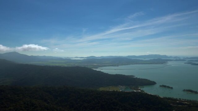 Panoramic landscape top view over Langkawi island, under blue cloudy sky.