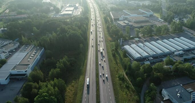 Aerial view of the busy highway road in Espoo, Finland with the traffic on each road on a sunset in Summer.
