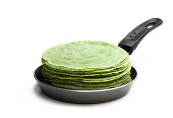 Green thin pancakes in small pan isolated on white