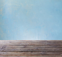 old wooden table on background blue wall