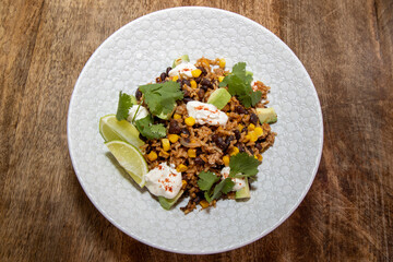 A delicious bowl of Crispy Pork Rice on a wooden kitchen table