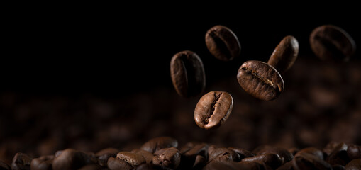 Close-up, fresh coffee beans falling on the ground