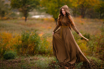 Redhead woman in dress walking in fantasy fairy tale forest - obrazy, fototapety, plakaty