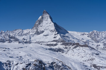 Beautiful winter mountain panorama with famous peak Matterhorn (4478m) seen from Gornergrat, Zermatt, Switzerland. Photo taken March 23rd, 2021.