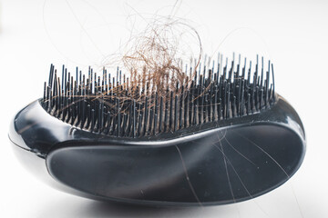 comb and women's hair , hair loss concept