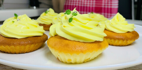 Cupcake on a plate close-up. Cupcake with yellow cream. Ready dessert for a children's holiday. Homemade food.