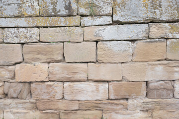 rough stone wall with weathered sandstone blocks