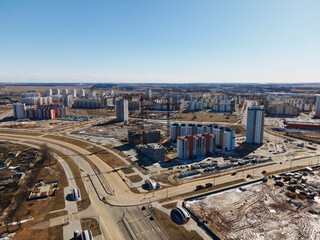 Aerial view of the new urban development. New houses are being built. Nearby are old houses for demolition.