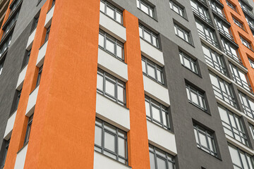 The facade of a multi-storey building with windows and balconies as an element of the architecture...