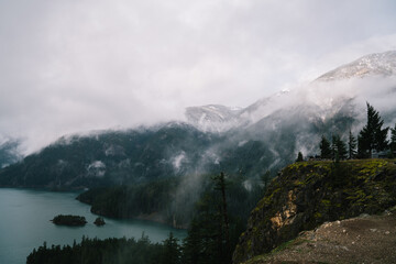 Natural landscape of foggy mountains and lake