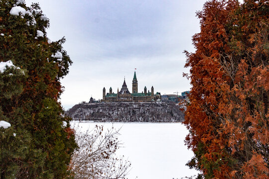 View Of Canadian Parliament In Winter From Across The River