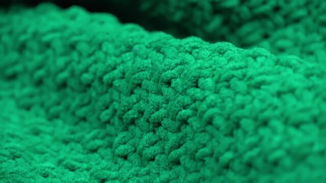 super close-up. Details of green knitted wool fabric. textile background. macro