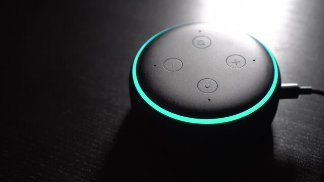A smart speaker device kicks in and the light ring is turned on. At home and at night.
