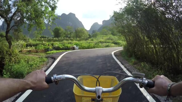 First person view bicycling in Yangshuo County China very popular chinese tourist destination for both foreign as domestic tourists area is known for the karst peaks mountains 4k high resolution