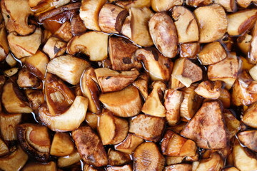  Cleaned and sliced the mushrooms are in the water. Summer and autumn seasons. Detox, fitness, cleansing, vegetable protein. Useful product. Top view.