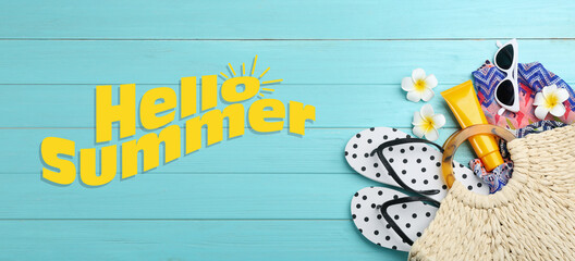 Hello Summer. Flat lay composition with beach accessories on light blue wooden background, banner design © New Africa