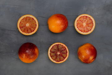 Blood orange on a table. Juicy red fruit texture close up. Gray background with copy space. Healthy...
