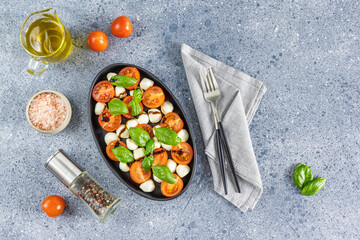 Caprese salad with cherry tomatoes, mozzarella and basil. Top view with space for your text