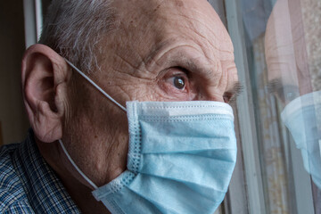 Large scale portrait of older man wearing medical face mask