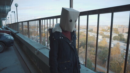 Girl with a package on the head at the multi-storey car park. Girl in a jacket
