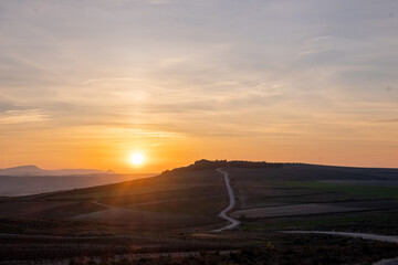 sunset over the mountains at the woods