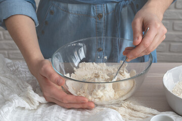 female hands preparing dough