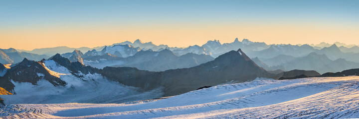 Mt. Elbrus glacier against Caucasus mountains in the evening before sunset. Panoramic view from 