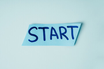 The inscription START on a blue piece of paper, the concept of beginnings in business, education and sports