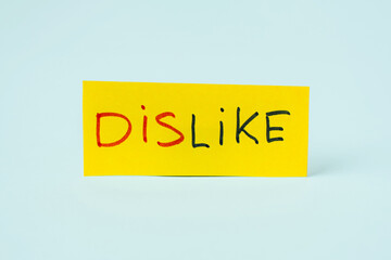 DISLIKE inscription on yellow paper, with the ability to cut off 