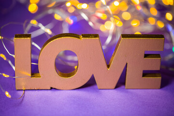 Love written with bokeh. Postcard, background, tulips