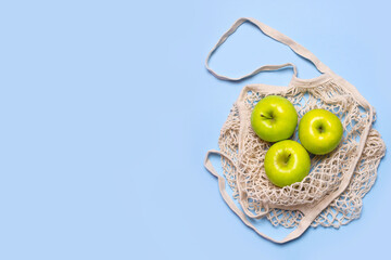 eco shopping bag with apples on a blue background