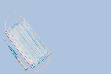 medical mask syringe with medicine for injection injection on blue background 