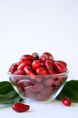 Ripe cornelian cherry. Dogwood fruits isolated on white background. Red berry Cornus