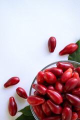 Ripe cornelian cherry. Dogwood fruits isolated on white background. Red berry Cornus