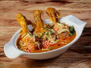 Nawabi murgh served on a rustic wooden background. Dishes and appetizers of indian cuisine, selective focus